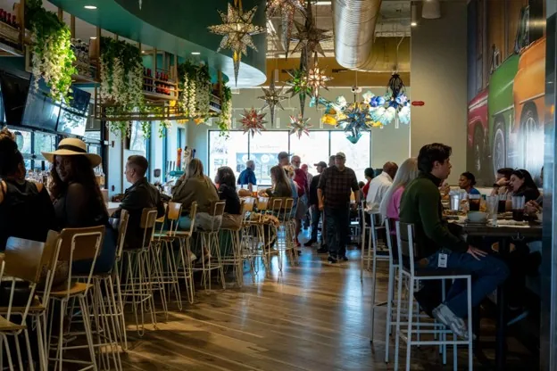 Bright, high-energy dining room and bar seating at Tequila Mama Taqueria